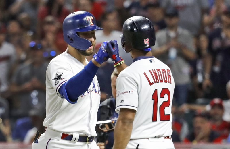 American League's Joey Gallo, left, of the Texas Rangers, is congratulated by American League teammate Francisco Lindor, of the Cleveland Indians, after Gallo hit a solo home run during the seventh inning of the MLB baseball All-Star Game, Tuesday, July 9, 2019, in Cleveland. (AP Photo/John Minchillo)