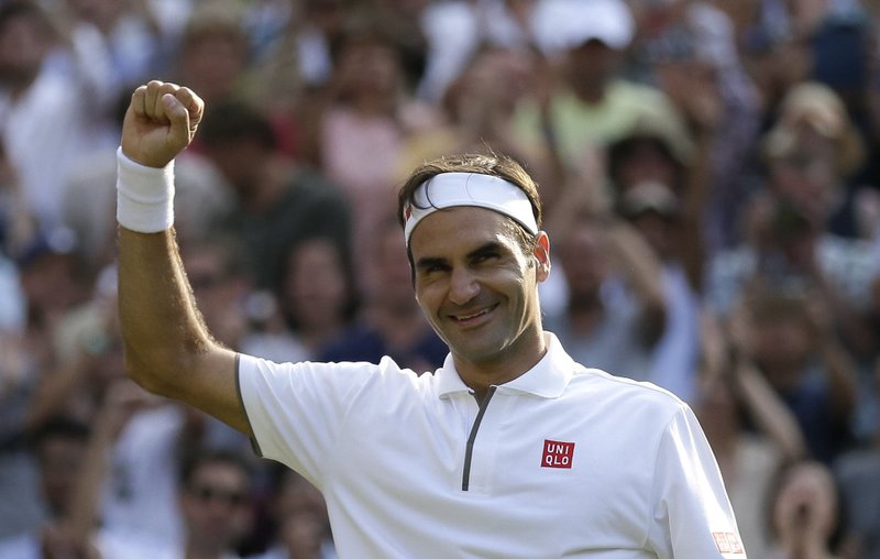 Switzerland's Roger Federer celebrates defeating Japan's Kei Nishikori during a men's quarterfinal match on day nine of the Wimbledon Tennis Championships in London, Wednesday, July 10, 2019. 