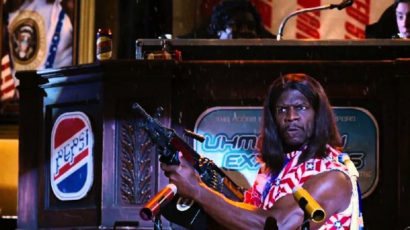 In Mike Judge’s Idiocracy, the United States is run by a former professional wrestler and porn star, President Dwayne Elizondo Mountain Dew Herbert Camacho (Terry Crews). Until recently, out critic Piers Marchant had never seen the film. 