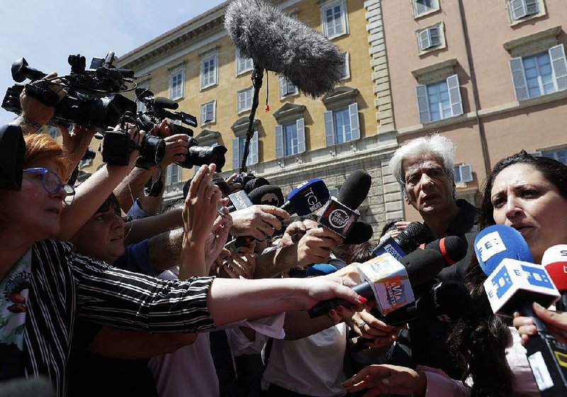 Pietro Orlandi (second from right) listens Thursday as attorney Laura Sgro discusses the empty tombs at the Vatican that were opened in the search for Orlandi’s long-missing sister but raised new questions. 