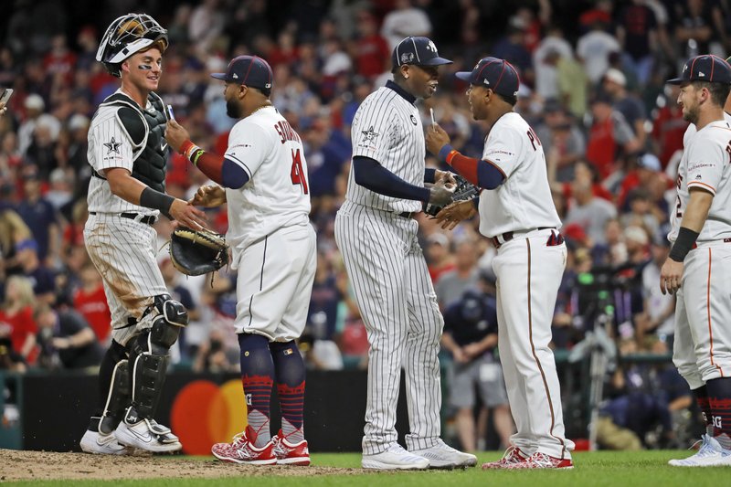 Members of the American League squad celebrate their 4-3 victory over the National League in the MLB baseball All-Star Game, Tuesday, July 9, 2019, in Cleveland. (AP Photo/John Minchillo)