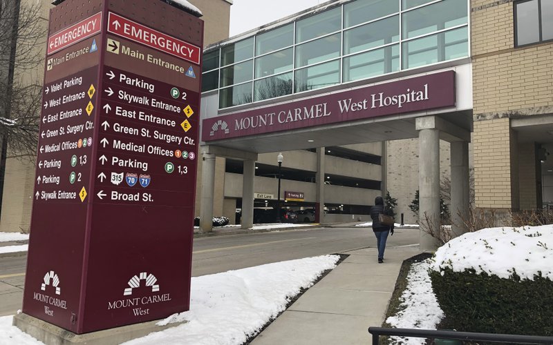 FILE - In this Jan. 15, 2019 file photo, the main entrance to Mount Carmel West Hospital is shown in Columbus, Ohio. The Mount Carmel Health System announced Thursday, July 11, 2019 that it&#x2019;s firing 23 more employees and changing leadership after investigating excessive painkiller doses given to dozens of patients who died. (AP Photo/Andrew Welsh Huggins, File)