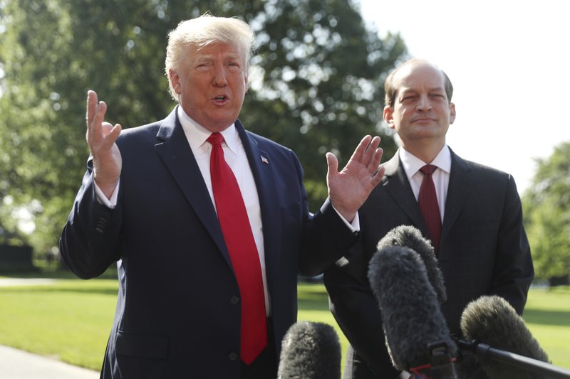 President Donald Trump speaks to members of the media with Secretary of Labor Alex Acosta on the South Lawn of the White House, Friday, July 12, 2019, before Trump boards Marine One for a short trip to Andrews Air Force Base, Md. and then on to Wisconsin. (AP Photo/Andrew Harnik)

