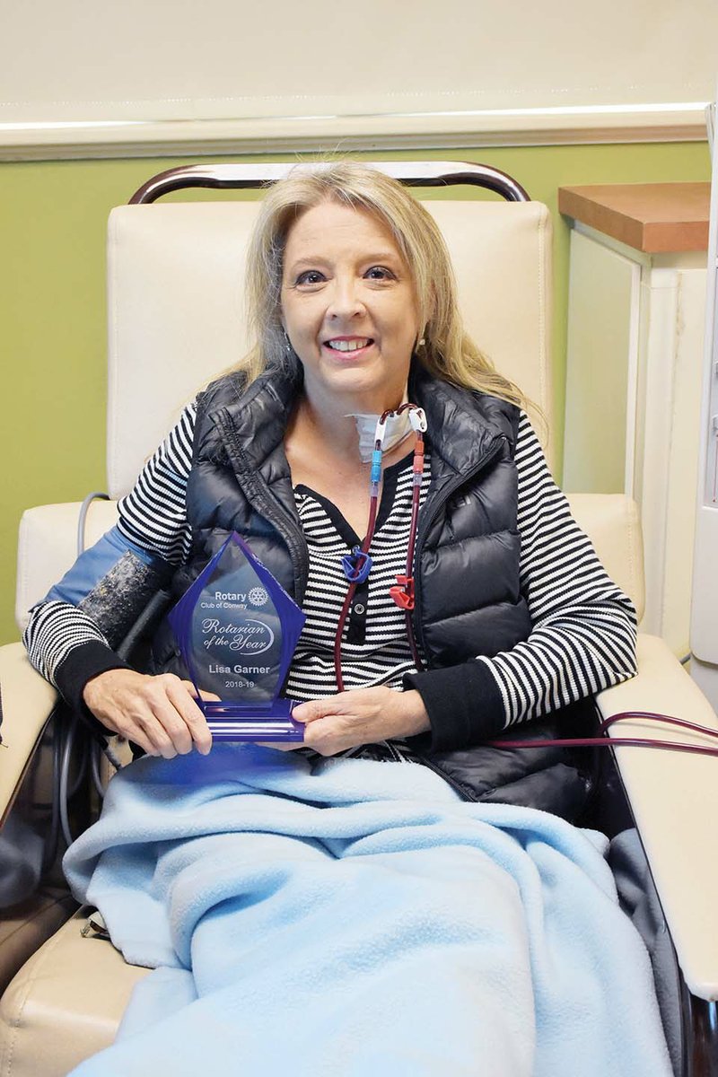 Lisa Garner holds her Rotarian of the Year award as she receives dialysis in Conway. Garner underwent a kidney transplant about 12 years ago, but she is in kidney failure and is awaiting a donor. Despite her health issues, according to the Conway Noon Rotary Club, she has been an invaluable member. Garner works with legislators on Capitol Hill to get the Living Donor Protection Act of 2019 passed so kidney donors are guaranteed their jobs after time off to make the donation.