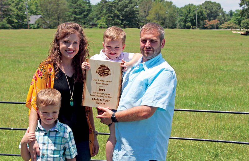 The Nelson family of Malvern is the 2019 Hot Spring County Farm Family of the Year. From left are Grant, 6; Piper; Noah, 4; and Chris. The Nelsons have 89 acres altogether, including 40 at their home in Malvern. 