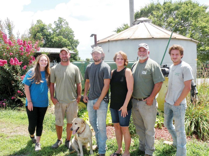 The family that runs Schaefers Brothers Farms of Conway is the 2019 Faulkner County Farm Family of the Year. Family members include, from left, Kennedy Hancock, James Schaefers, Kyle Schaefers, Debbie Schaefers, Chris Schaefers and Caleb Schaefers. Chris and James raise rice, corn, soybeans, wheat, hay and cattle. Sage, the farm dog, is always nearby.