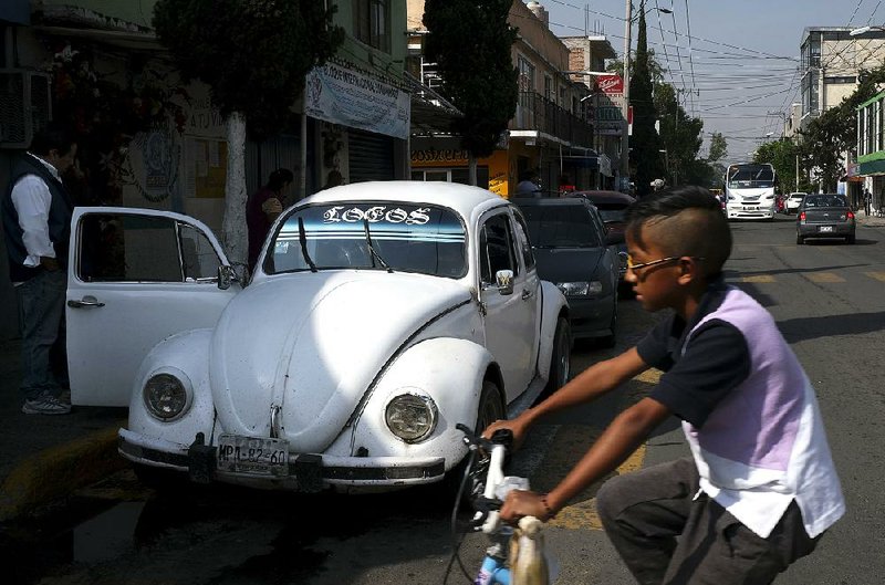 A Volkswagen Beetle waits in a taxi lane in a neighborhood of Mexico City known colloquially as “Vocholandia” for its love of the classic Beetle, called “vocho.” 