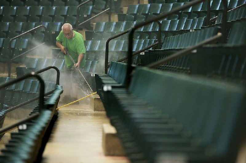 Carolina Cleaner employee David Hill continues power washing the risers and seats at the BancorpSouth Arena in Tupelo, Miss., as they prepare the site for new seats around the upper bowl in early July. 