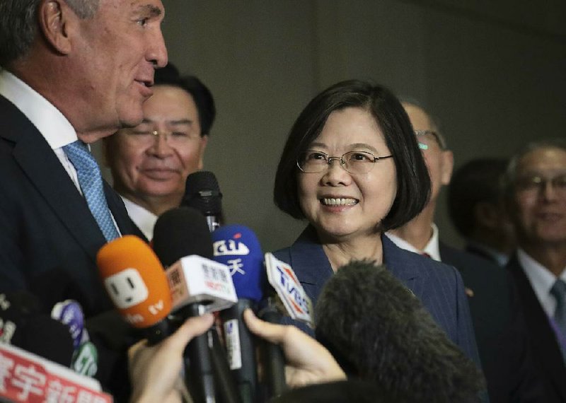 Taiwanese President Tsai Ing-wen (center) and Michael Splinter (left), chairman of the Taiwan U.S. Chamber of Commerce, speak to reporters as the two arrive Friday in New York for a chamber conference. 