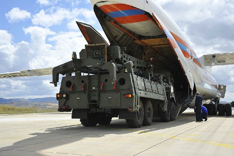 Parts of the S-400 air-defense systems are unloaded from a Russian transport Friday at the Murted air base in Ankara, Turkey. 