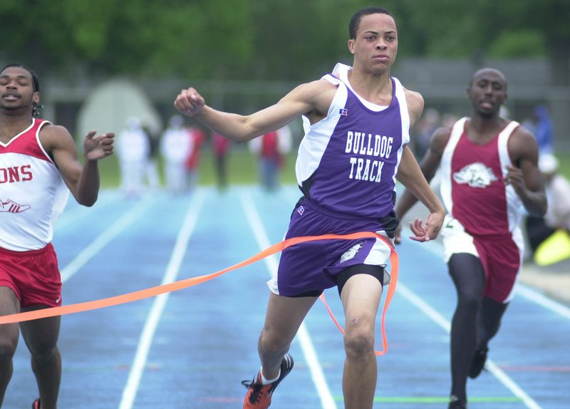 STAFF PHOTO ANDY SHUPE Wallace Spearmon, center, shown winning his heat in the 100 meters at the state track meet his senior year, was a three-sport standout at Fayetteville High School, but went on to be a two-time NCAA champion in the 200 meters and an Olympian.