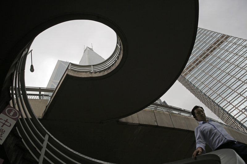 In this July 10, 2019, photo, a man walks on a bridge near the Bank of China Tower at Central, a business district of Hong Kong. It&#x2019;s still the world&#x2019;s &#x201c;freest&#x201d; economy, one of the biggest global financial centers and a scenic haven for tycoons and tourists, but the waves of protests rocking Hong Kong are exposing strains unlikely to dissipate as communist-ruled Beijing&#x2019;s influence grows. (AP Photo/Kin Cheung)