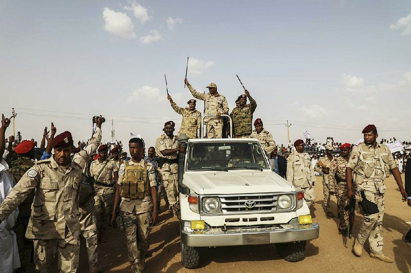 Gen. Mohamed Hamdan Dagalo and others from Sudan’s military wave to a crowd of supporters during a rally Saturday in the Nile River province.