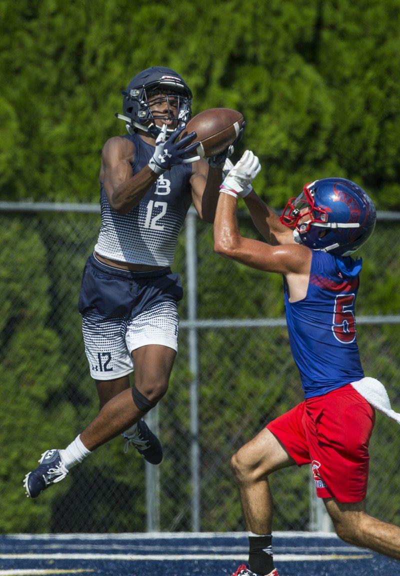 NWA Democrat-Gazette/BEN GOFF @NWABENGOFF
Micah Seawood (12), Springdale Har-Ber wide receiver, makes a touchdown catch as Trevon Holt, Bixby (Okla.) defensive back, defends in the first game Saturday, July 13, 2019, during the championship round of the Southwest Elite 7-on-7 tournament at Shiloh Christian's Champions Stadium in Springdale. 