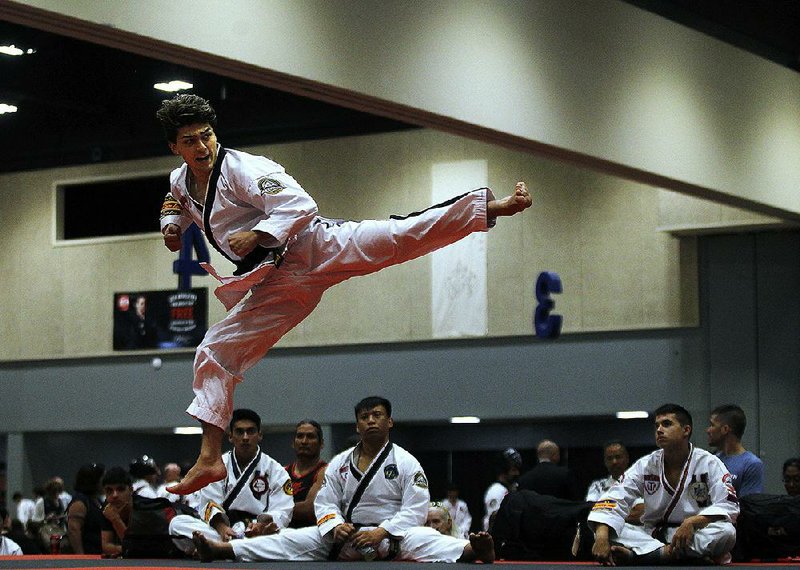 Arkansas Democrat-Gazette/THOMAS METTHE -- 7/14/2019 --
Jordan Peters of Phoenix, Arizona, competes in the traditional forms competition on Sunday, July 14, 2019, during the 2019 ATA World Expo at the Statehouse Convention Center in Little Rock. 
See more photos at www.arkansasonline.com/715ata/