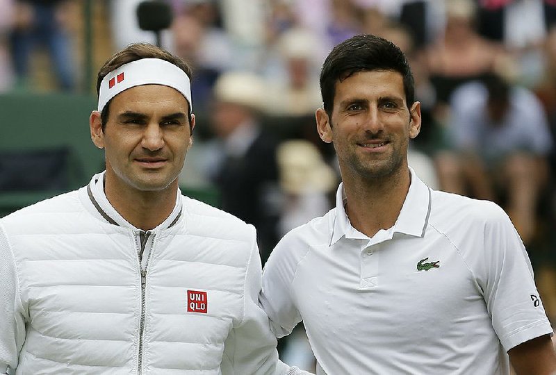 Serbia's Novak Djokovic, right, poses with Switzerland's Roger Federer before the men's singles final match of the Wimbledon Tennis Championships in London.