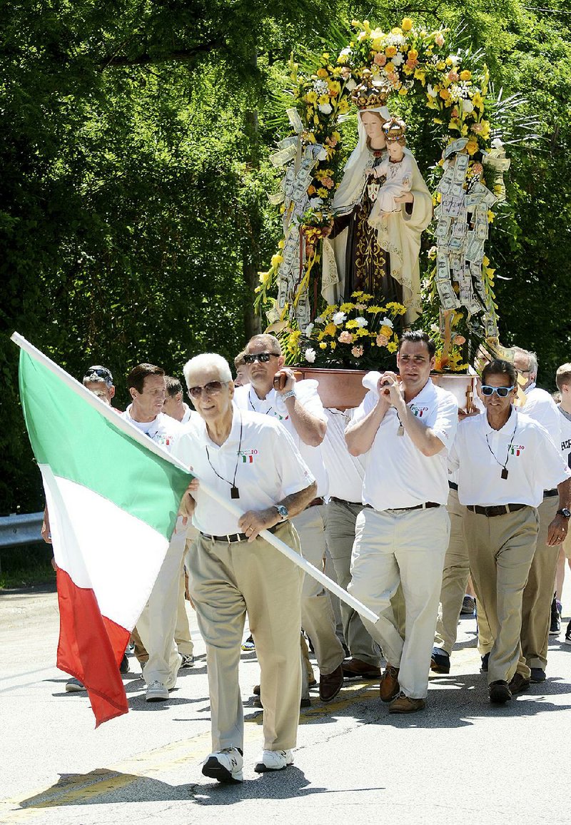 People carry a statue of the Virgin Mary during the Our Lady of Mount Carmel procession Sunday afternoon in Ashtabula, Ohio. 