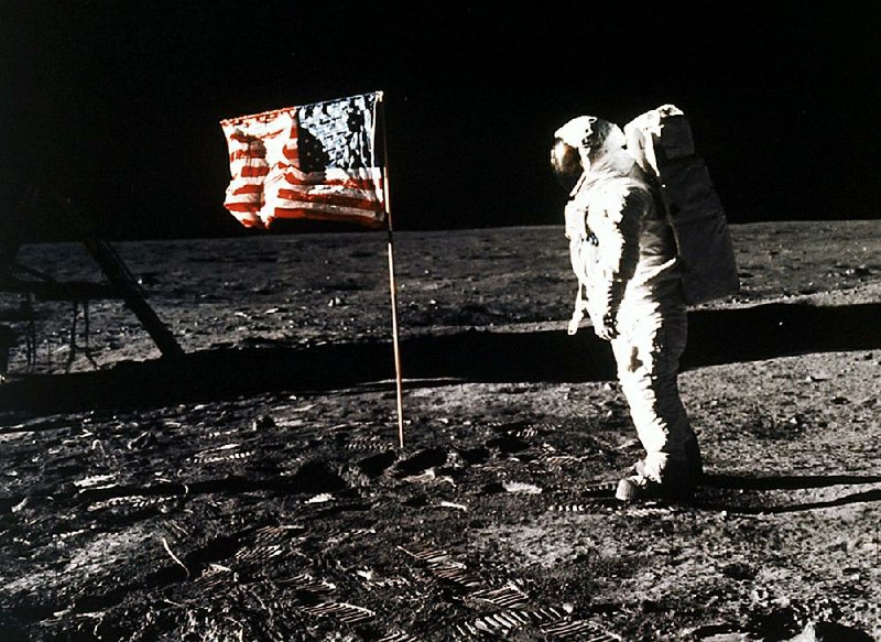 Edwin E. “Buzz” Aldrin Jr. poses so Neil Armstrong can snap his photo July 20, 1969, with the U.S. flag on the moon. 