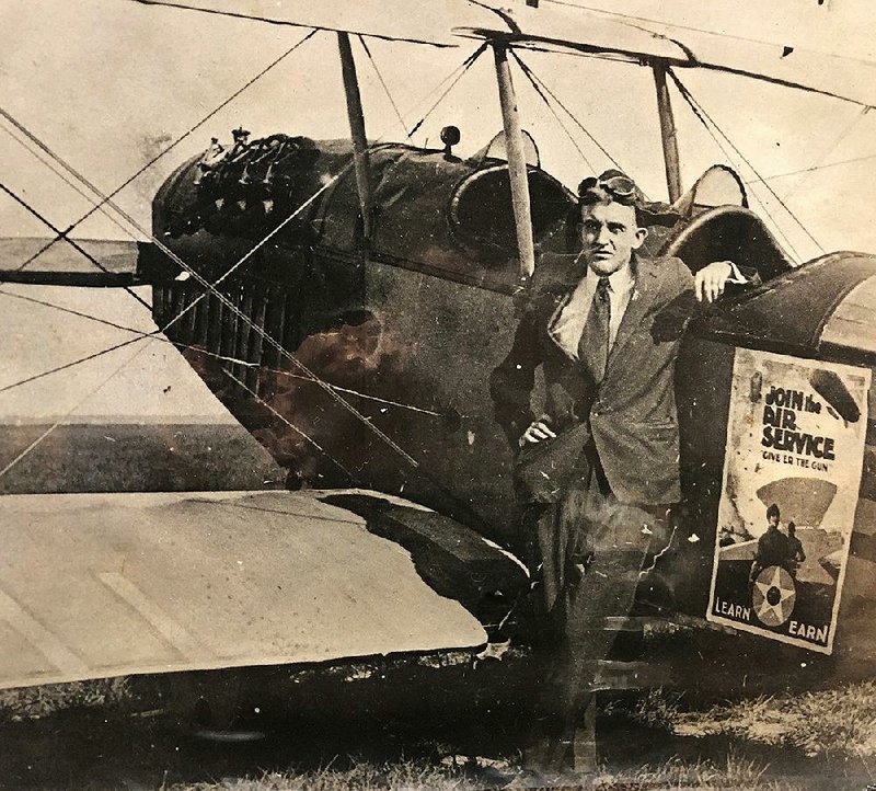 Arkansas Gazette night editor Clyde Dew, having just witnessed a fatal collision of Army biplanes, leans July 12, 1919, on the craft in which he was a passenger. 