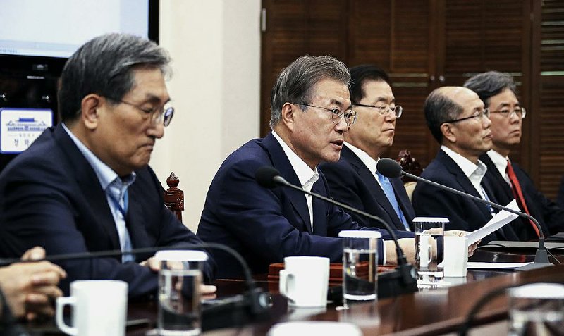 South Korean President Moon Jae-in (second from left) speaks Monday in Seoul about the trade dispute, urging Japan to lift its tightened controls on high-tech exports to South Korea. 