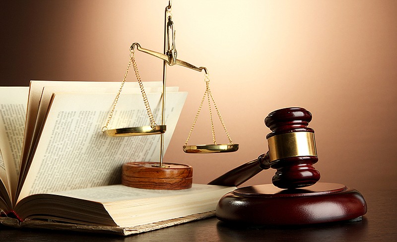 A gavel and the scales of justice are shown in this photo.