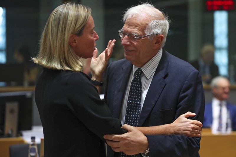 European Union foreign policy chief Federica Mogherini, left, talks to Spain's Foreign Minister Josep Borrell during a European Foreign Affairs meeting at the European Council headquarters in Brussels, Monday, July 15, 2019. European Union nations were looking to deescalate tensions in the Persian Gulf area on Monday and call on Iran to stick to the 2015 nuclear deal, despite the pullout of the United States from the accord and the re-imposition of U.S. sanctions on Tehran. (AP Photo/Francisco Seco)