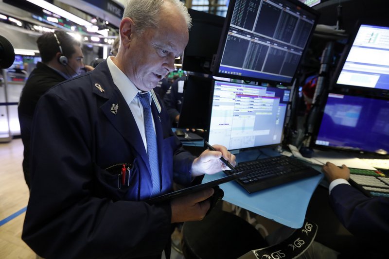 FILE - In this July 1, 2019, file photo trader James Riley works on the floor of the New York Stock Exchange. The U.S. stock market opens at 9:30 a.m. EDT on Monday, July 15. (AP Photo/Richard Drew, File)