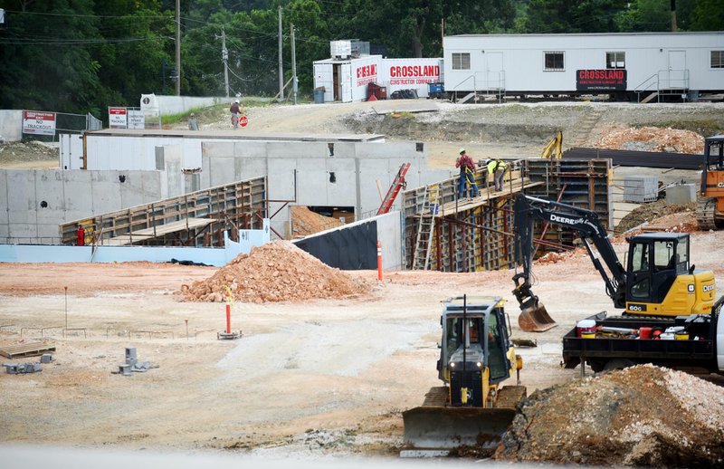 NWA Democrat-Gazette/DAVID GOTTSCHALK Work continues Monday on the Fayetteville Public Library's expansion. The more than 80,000-square-foot addition has most of the utility and foundation work completed, with an expected completion date of October next year.
