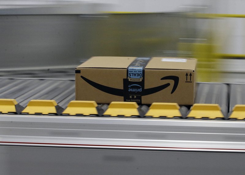 FILE - In this Feb. 9, 2018, file photo a box for an Amazon prime customer moves through the new Amazon Fulfillment Center in Sacramento, Calif. This year Prime Day is happening on two days: Monday, July 15, 2019, and Tuesday, July 16. (AP Photo/Rich Pedroncelli, File)
