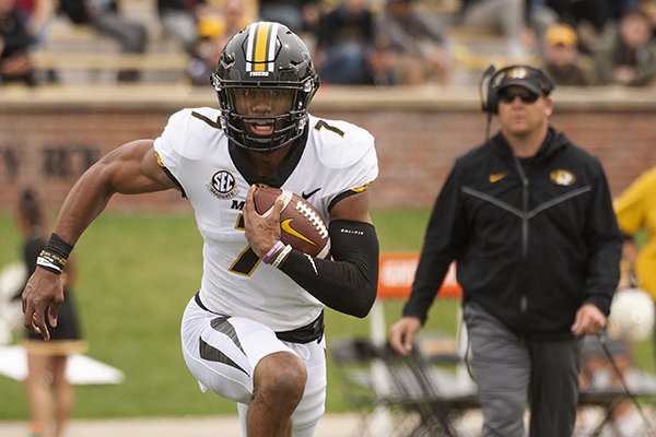 Missouri quarterback Kelly Bryant, left, scrambles for a gain in front of head coach Barry Odom, right, during an NCAA college football intrasquad spring game Saturday, April 13, 2019, in Columbia, Mo. (AP Photo/L.G. Patterson)

