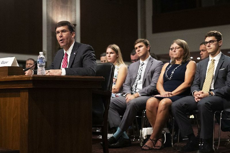 Secretary of the Army and secretary of defense nominee Mark Esper, accompanied by his family (from back, left) daughter Kate; son Luke; wife, Leah, and son John, testifies before a Senate Armed Services Committee confirmation hearing Tuesday on Capitol Hill. 