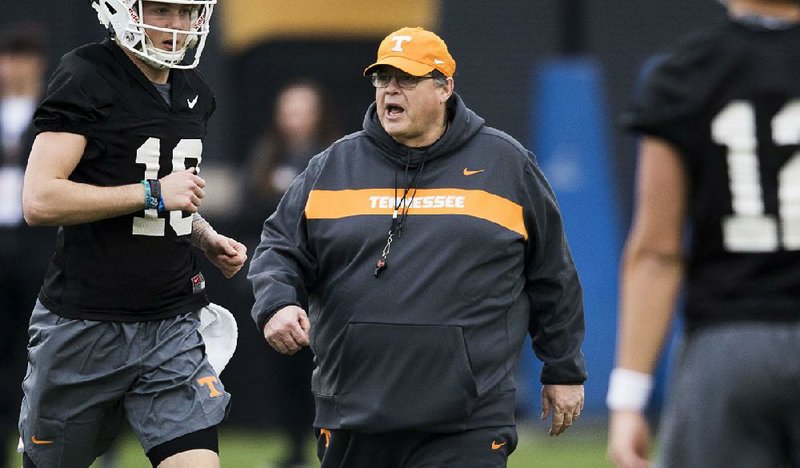 Jim Chaney (center), who coached at the University of Arkansas, begins his second stint as Tennessee’s offensive coordinator this season. “Wherever he’s been he’s had a lot of success, and he’s done it a bunch of different ways,” Volunteers Coach Jeremy Pruitt said. 