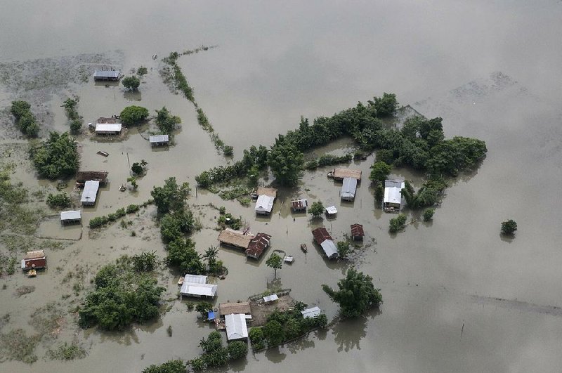Floodwaters surround Majuli, an island in the Brahmaputra River in northeastern India, on Tuesday in this view from the air. 