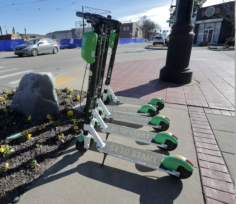 Lime scooters are lined up at Sixth and Main Streets in North Little Rock. (Arkansas Democrat-Gazette/JOHN SYKES JR.)
