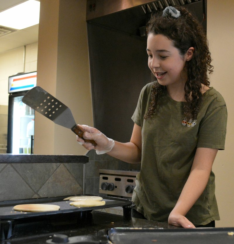 Sierra Bush/Herald-Leader Miah Anchondo, an eighth grader, learns about chemical combinations and the reactions that make pancakes rise during John Brown University's summer Scholars Academy Friday, an educational day camp that occurred twice this summer.