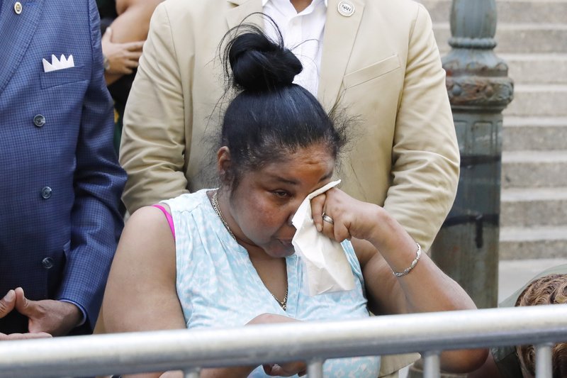 Esaw Snipes, widow of chokehold victim Eric Garner, wipes her eyes during a news conference outside the U.S. Attorney's office, in the Brooklyn borough of New York, Tuesday, July 16, 2019. Federal prosecutors won't bring civil rights charges against New York City police officer Daniel Pantaleo, in the 2014 chokehold death of Garner, a decision made by Attorney General William Barr and announced one day before the five-year anniversary of his death, officials said. (AP Photo/Richard Drew)