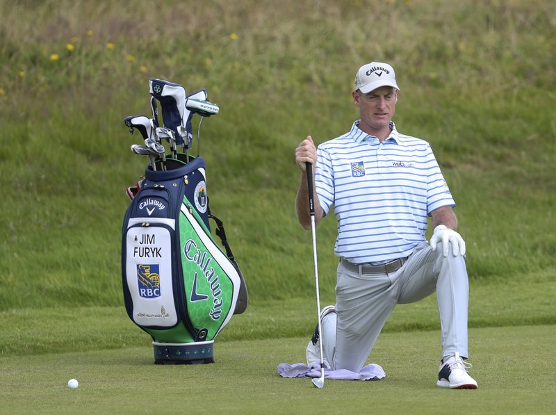 Jim Furyk of the United States stretches on the 1st fairway during a practice round for the British Open Golf championships at Royal Port Rush golf course in Northern Ireland, Tuesday, July 16, 2019. The British Open starts Thursday. (AP Photo/Str)