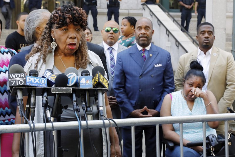 Gwen Carr, mother of chokehold victim Eric Garner, left, speaks outside the U.S. Attorney's office, in the Brooklyn borough of New York, as Garner's widow Esaw Snipes listens at right, Tuesday, July 16, 2019. Federal prosecutors won't bring civil rights charges against New York City police officer Daniel Pantaleo, in the 2014 chokehold death of Garner, a decision made by Attorney General William Barr and announced one day before the five-year anniversary of his death, officials said. (AP Photo/Richard Drew)