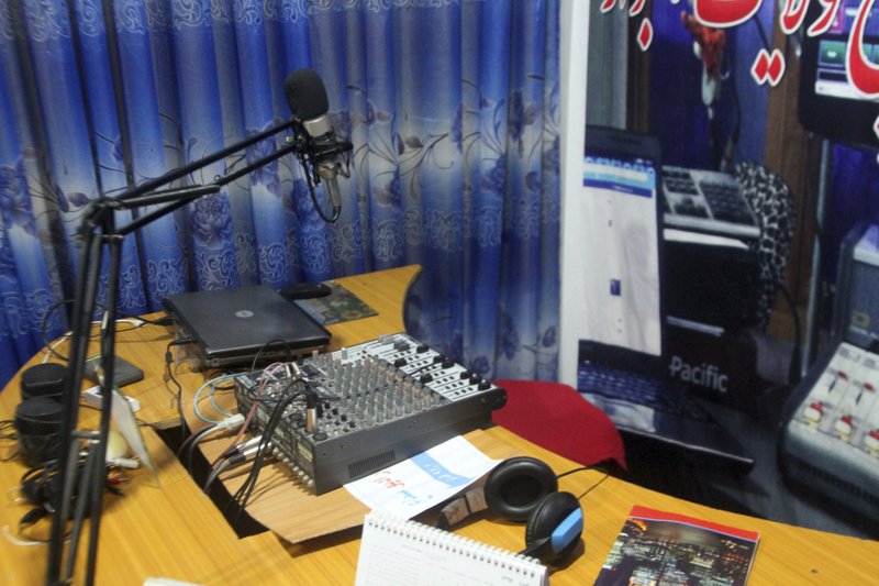 A microphone and a headset stands on the desk of the Samaa local radio Studio in the city of Ghazni province eastern of Kabul, Afghanistan, Tuesday, July 16, 2019. The Samaa local radio eastern Afghanistan was forced to shut down after repeated threats from the area's Taliban commander, the head of the station said on Tuesday. (AP Photo/Rahmatullah Nikzad)