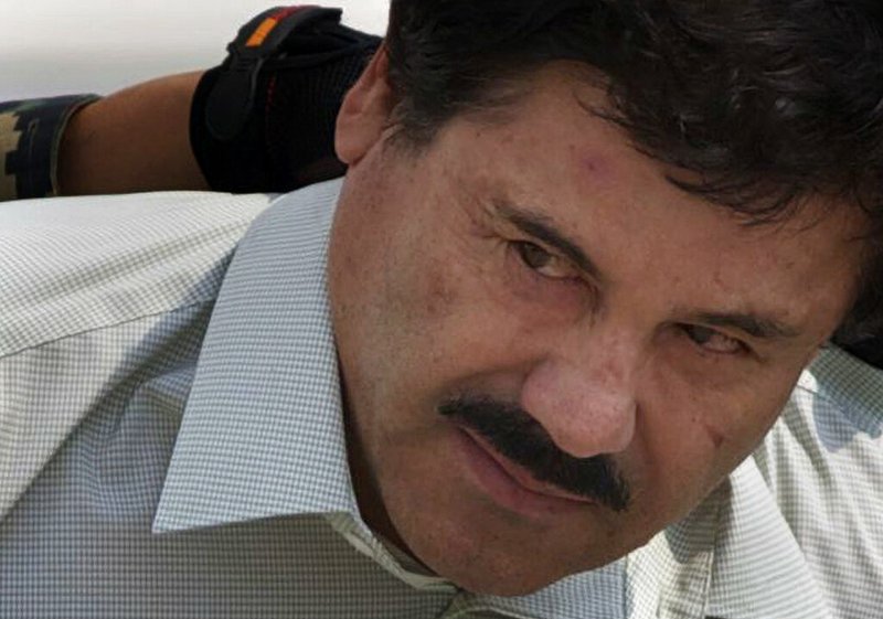 In this Feb. 22, 2014, file photo, Joaquin "El Chapo" Guzman is escorted to a helicopter in handcuffs by Mexican navy marines at a navy hanger in Mexico City. Guzman, who was convicted in February 2019 on multiple conspiracy counts in an epic drug-trafficking case, will be sentenced in a New York courtroom on Wednesday, July 17, 2019. (AP Photo/Eduardo Verdugo, File)