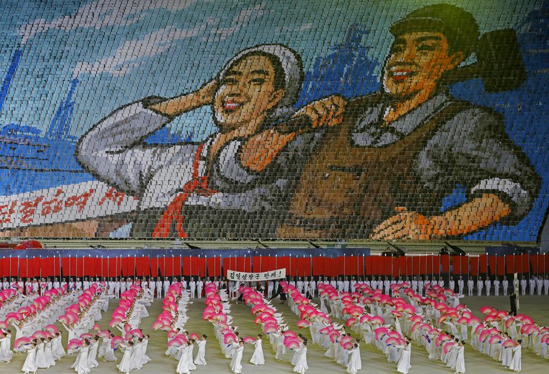 In this Tuesday, July 16, 2019, photo, North Koreans hold cards to make an image depicting a worker and a farmer during a mass game performance of "The Land of the People" at the May Day Stadium in Pyongyang, North Korea. (AP Photo/Vincent Yu)