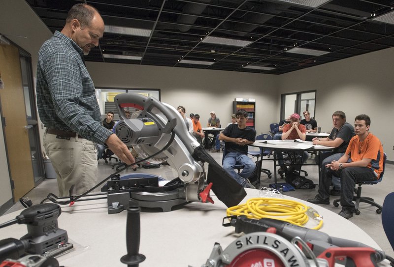 NWA Democrat-Gazette/J.T. WAMPLER Chris Weeks, the construction professions teacher at Bentonville West High School, shows students a variety of power tools Tuesday Aug. 23, 2016.