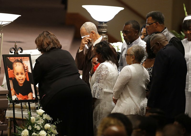 In this July 28, 2018, file photo, members of the Coleman family comfort each other at a casket during the showing for Horace Coleman, Belinda Coleman, Irvin Coleman, Angela Coleman and Maxwell Coleman in Indianapolis. Nine members of the Coleman family were killed in a duck boat accident on July 19, 2018, at Table Rock Lake near Branson Mo. A year after a duck boat sank and killed 17 people in a Missouri lake, the future of the tourist attraction remains a topic of debate. (AP Photo/Darron Cummings, File)