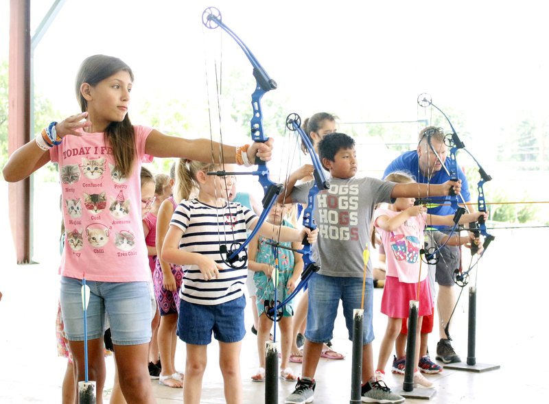 Children aim and fire during an event held by the Barton Public Library on Wednesday. Instruction and equipment was provided by Brent Smith of Slingin’ Arrows, located on Main Street in El Dorado. Caleb Slinkard/News-Times