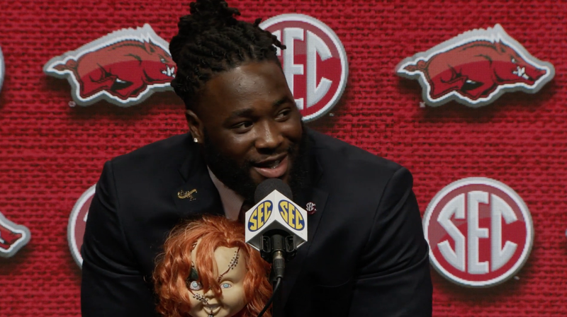 Arkansas defensive lineman McTelvin Agim speaks to reporters at an SEC Media Days interview on Wednesday. During the interview, Agim had a doll depicting the movie character Chucky with him. 