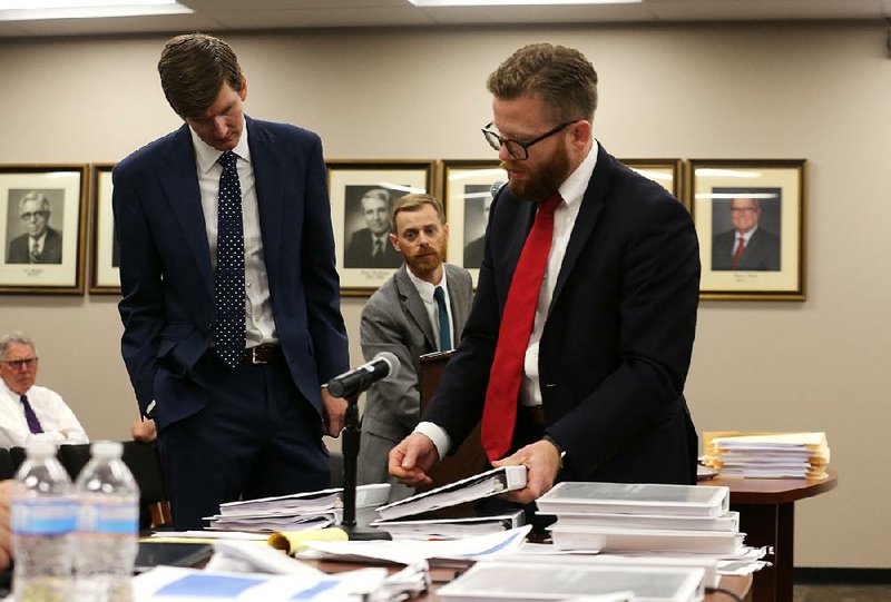 Jeff Ford (left), a private appraiser hired by Walmart, is questioned Wednesday by Walmart attorney Ryan Wilson during the hearing on Walmart’s property taxes in Little Rock.