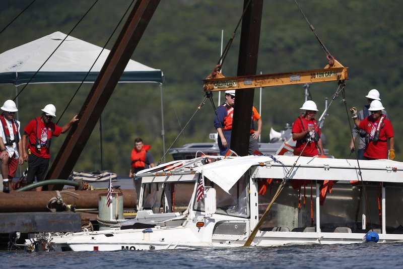 FILE - In this July 23, 2018, file photo, a duck boat that sank in Table Rock Lake in Branson, Mo., is raised after it went down the evening of July 19 after a thunderstorm generated near-hurricane strength winds, killing 17 people. A year after a duck boat sank and killed 17 people in a Missouri lake, the future of the tourist attraction remains a topic of debate. (Nathan Papes/The Springfield News-Leader via AP, File)