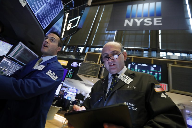 In this July 1, 2019, file photo specialist Michael Gagliano, left, and trader Andrew Silverman work on the floor of the New York Stock Exchange. (AP Photo/Richard Drew, File)