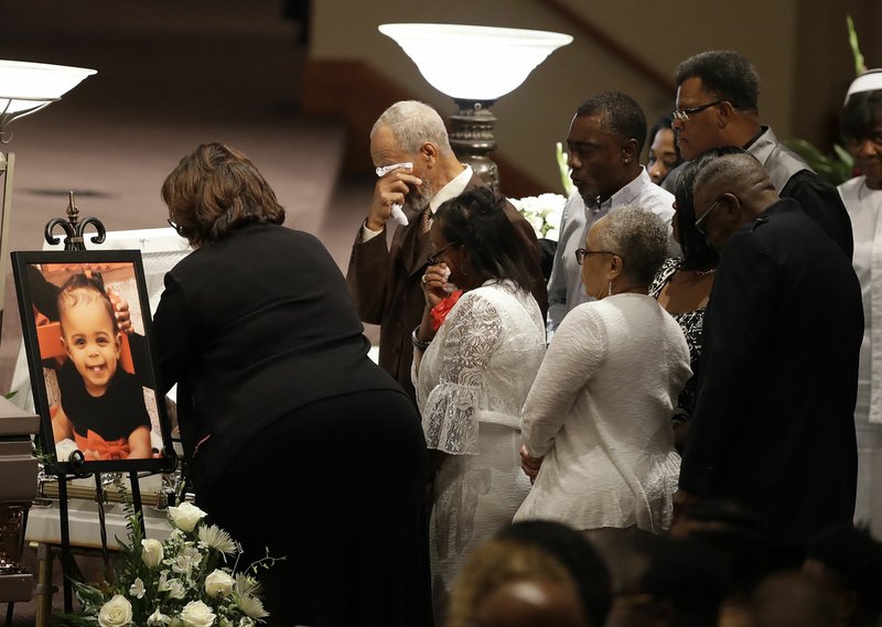 File photo/AP/DARRON CUMMINGS Members of the Coleman family comfort each other inn July 2018 at a casket during the viewing for Horace Coleman, Belinda Coleman, Irvin Coleman, Angela Coleman and Maxwell Coleman in Indianapolis. Nine members of the family were killed in a duck boat accident at Table Rock Lake near Branson, Mo.