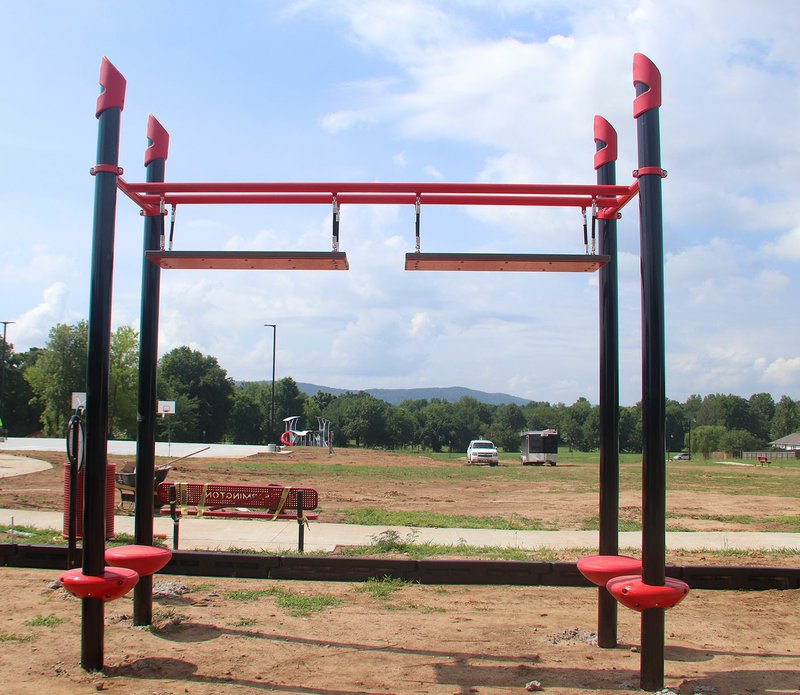 NWA Democrat-Gazette/LYNN KUTTER Participants using the unstable bridge station will hold onto both sides of the first plank and use momentum to reach the second plank.